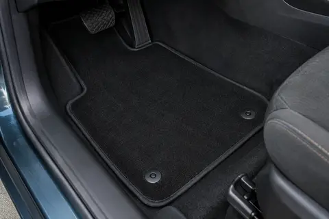 Tapis de sol Carmats noir en moquette, avec deux fixations et une bordure antidérapante, dans un habitacle