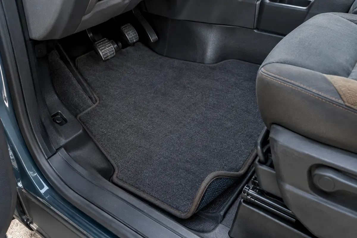 Tapis en feutre aiguilleté ajusté au plancher d’un camping-car Ford Transit, avec bords gansés